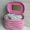 A pink striped Y2K makeup bag with a mirror and zipper, made of cotton toiletry pouch material.
