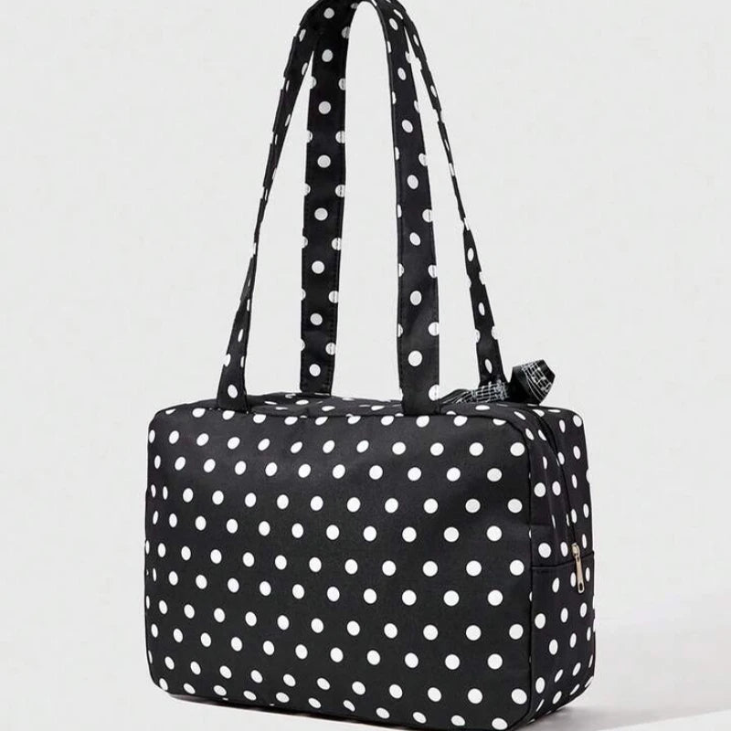 Black tote bag with white polka dots featuring piano lace trim and a bow detail