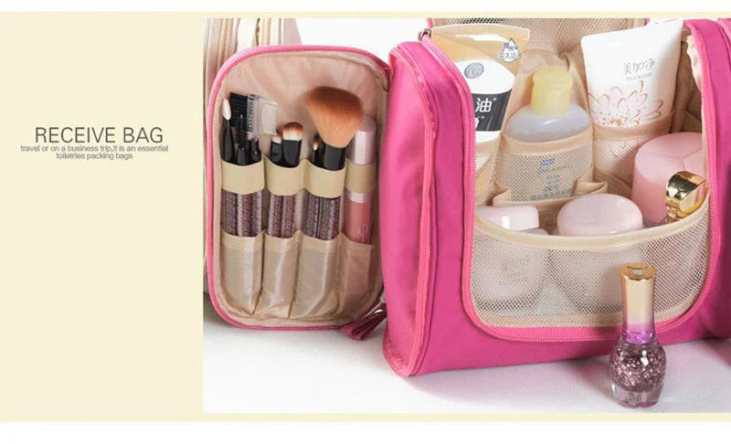 A pink multi-compartment travel pouch containing various cosmetic and grooming items like brushes and creams.