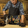 A man wearing an apron is using an adjustable utility tool belt bag to hold various tools while working on wood.