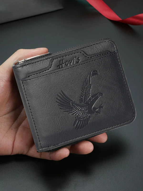 A dark gray embossed PU leather slim wallet with a bird design is held in a hand.