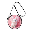 A pink round crossbody bag featuring a cartoon white kitten design with the text Love and tiny hearts.