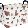 A light-colored fabric storage basket with handles, featuring a repeating pattern of woodland animals like deer and foxes.