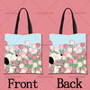 A pink background showing a tote bag design featuring a floral pattern with a cartoon dog face on the front and back.