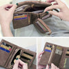 A close-up of a brown multi-slot card wallet with a zipper closure showing various cards and cash inside.