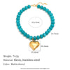 A necklace featuring light blue beads and a gold heart charm, made with resin and stainless steel.