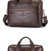 A dark brown full-grain leather executive laptop briefcase with padded straps and a top handle.