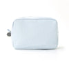 A light blue and white striped seersucker cosmetic bag with a zipper closure.