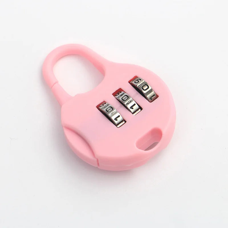 A pink compact 3-digit combination travel lock with a loop handle and three numbered dials.