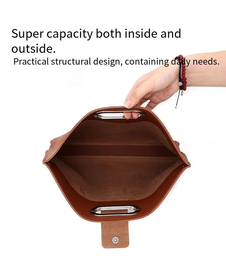 A brown leather laptop briefcase with a flap closure is shown being held by a hand.