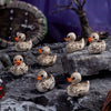 A collection of small, realistic duck figurines with mottled brown and white feathers displayed on dark rocks.