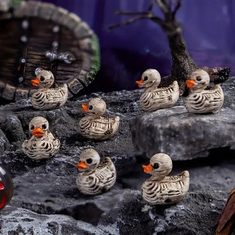A collection of small, realistic duck figurines with mottled brown and white feathers displayed on dark rocks.