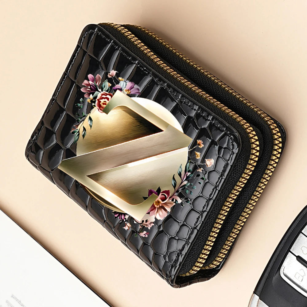 A black PU leather double-zip clutch wallet featuring a gold-toned geometric design and floral print.