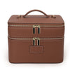 A brown double-layer makeup storage case with a leather handle and gold zippers.