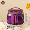 A purple waterproof travel toiletry bag with a brown handle and black zipper is shown on a white box.