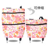 Pink floral folding shopping trolley bag with black trim and wheels