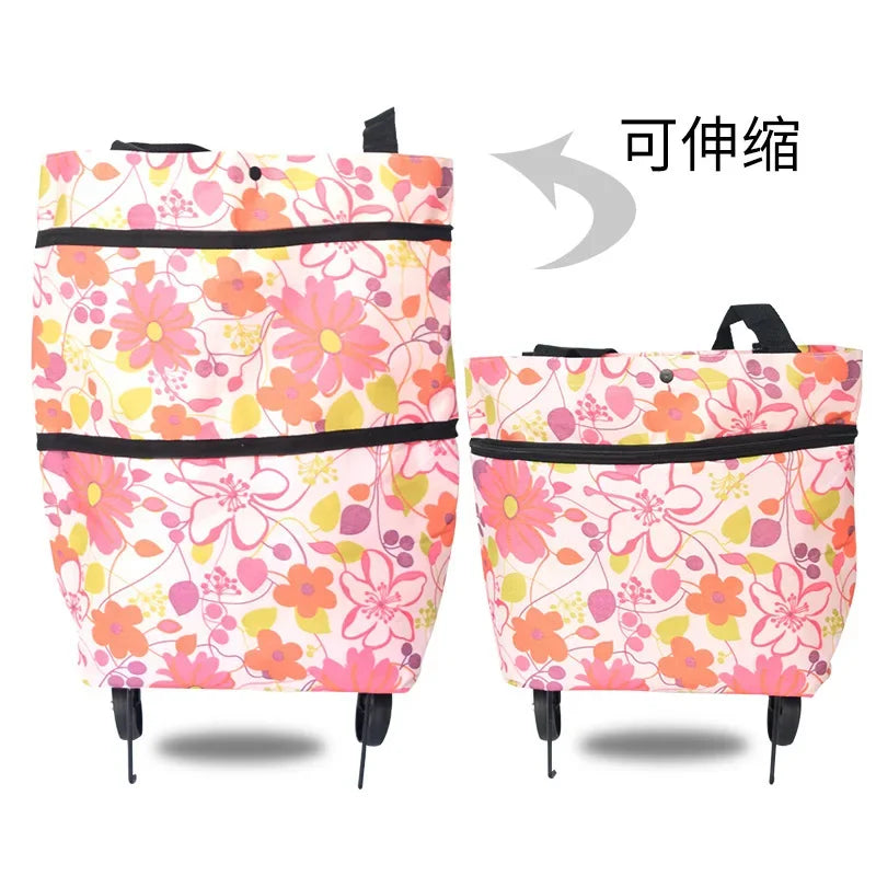 Pink floral folding shopping trolley bag with black trim and wheels