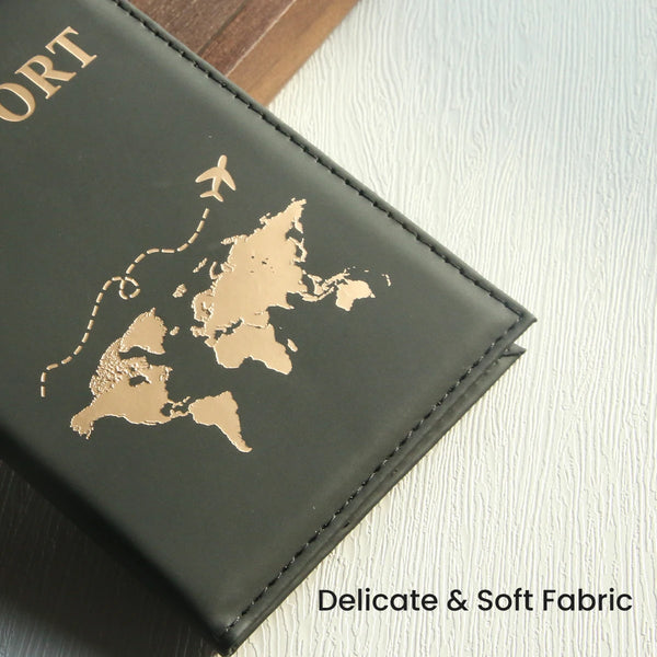 A dark green leather passport holder featuring a gold-colored map of the world and an airplane silhouette.
