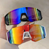 A hand holds a pair of lightweight oversized sunglasses with vibrant iridescent blue and orange lenses.