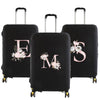 Black luggage with a pink floral design featuring the letters E and M