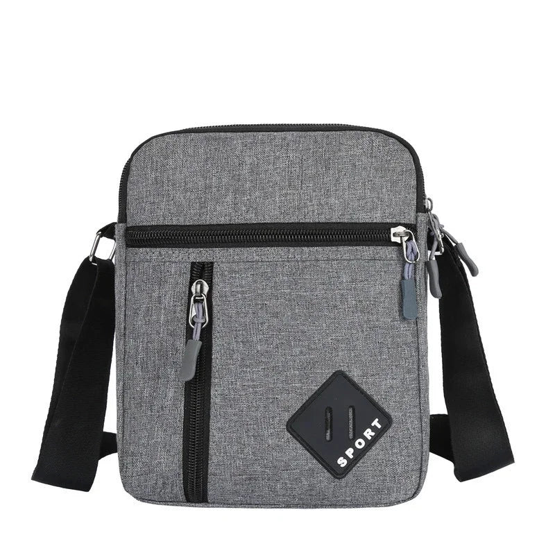 A gray men's lightweight crossbody sling bag with black straps and a zippered pocket.