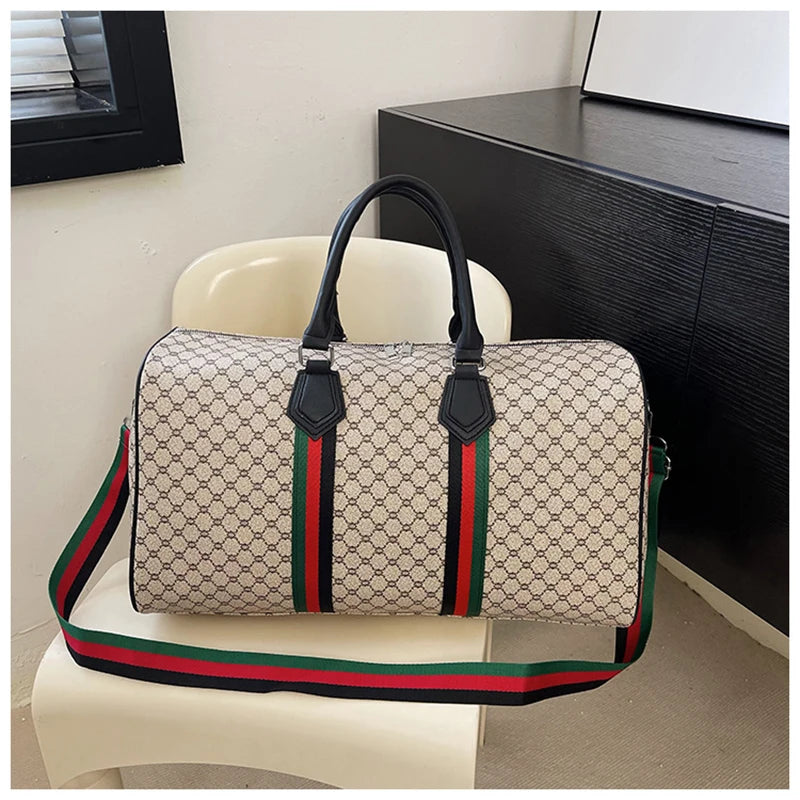 A women's plaid travel duffle bag in beige and green fabric resting on a white chair.