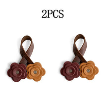 Two handmade PU leather rose bag charms in shades of brown and tan.