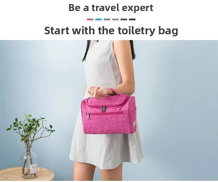 A woman holds a pink portable Oxford cloth toiletry bag against a light blue background.
