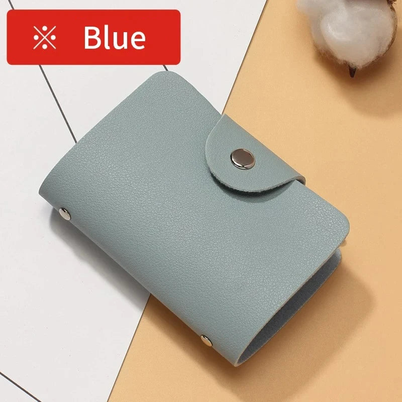 A light blue premium PU leather wallet is shown lying on a beige surface.