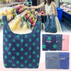 A dark blue reusable shopping bag with green stars is shown in a vertical layout.