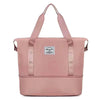 A pink expandable travel organizer bag with two handles shown against a white background.