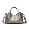A smooth, taupe-gray leather women's casual crossbody shoulder bag with a top handle.