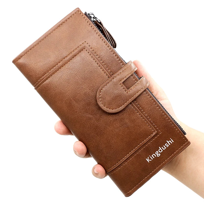 A brown leather wallet is held in a hand, showing its design and stitching.