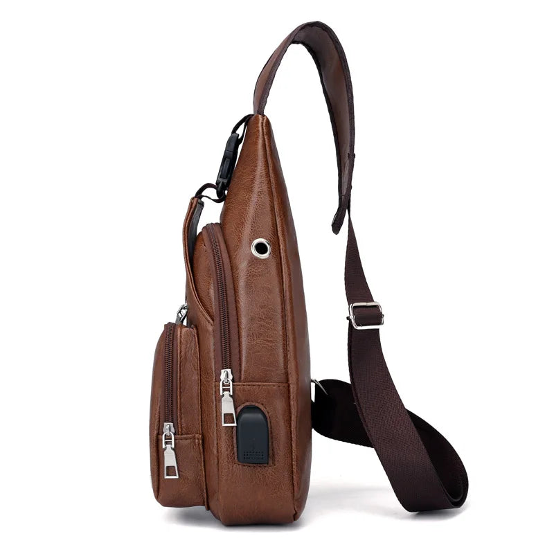 A brown leather men's chest bag with a strap and headphone port.
