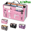 A pink multi-pocket organizer tote bag filled with various cosmetic and essential items.