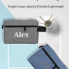 A gray makeup wash bag embroidered with the name Alex is shown next to a white rolled towel.