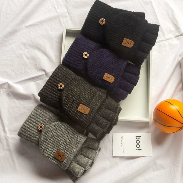A stack of warm knitted fingerless gloves in various shades of gray and purple are displayed on a white tray.