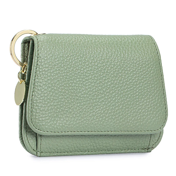 A light sage green genuine leather slim trifold wallet with a zipper pouch and gold hardware.
