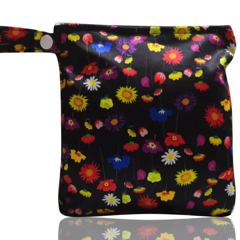 A black reusable waterproof snack bag decorated with colorful floral patterns and featuring a zipper closure.