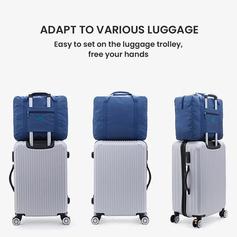 A blue foldable travel duffel bag is shown with a luggage strap, next to a silver suitcase.