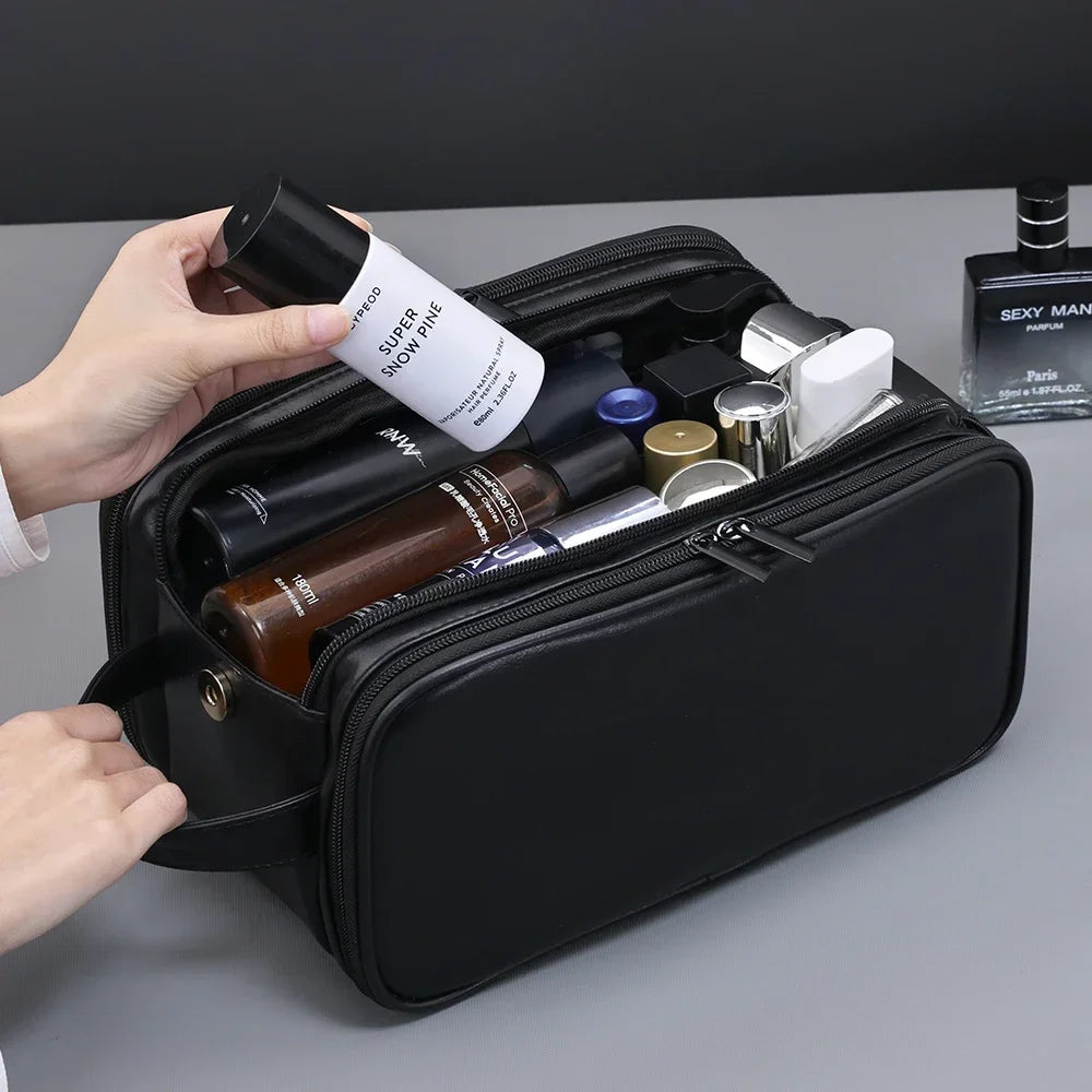A black PU leather travel toiletry bag is open, showing various beauty products and a perfume bottle.