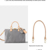 A grey canvas handbag with a tan leather replacement shoulder strap is shown next to the strap.