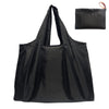A black canvas tote shopping bag with a drawstring closure is shown against a white background.