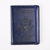 A dark blue leather passport holder with embossed text and an eagle design.