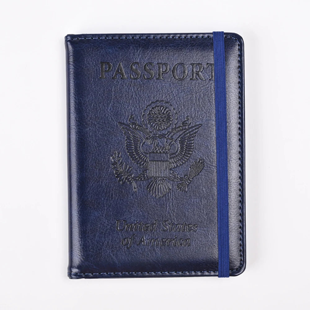 A dark blue leather passport holder with embossed text and an eagle design.