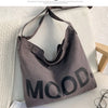 A gray canvas tote bag featuring the word MOOD printed in black text, displayed on a light surface.