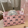 Pink quilted cotton storage basket with black bow pattern and lace flower design