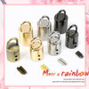 A collection of metal cord lock buckles in various finishes including gold, silver, and black.