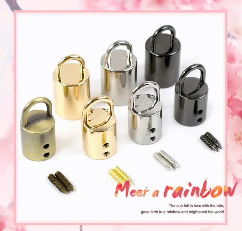 A collection of metal cord lock buckles in various finishes including gold, silver, and black.