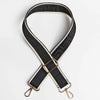 A black adjustable crossbody bag strap featuring a maze pattern and gold-toned hardware.